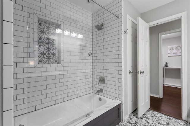 bathroom with wood-type flooring and tiled shower / bath