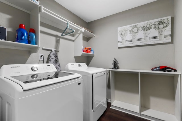 laundry area with dark wood-type flooring and independent washer and dryer