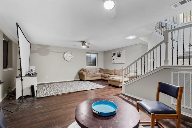 living room featuring ceiling fan and hardwood / wood-style flooring