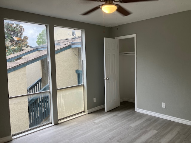 unfurnished bedroom featuring a closet, ceiling fan, and hardwood / wood-style floors