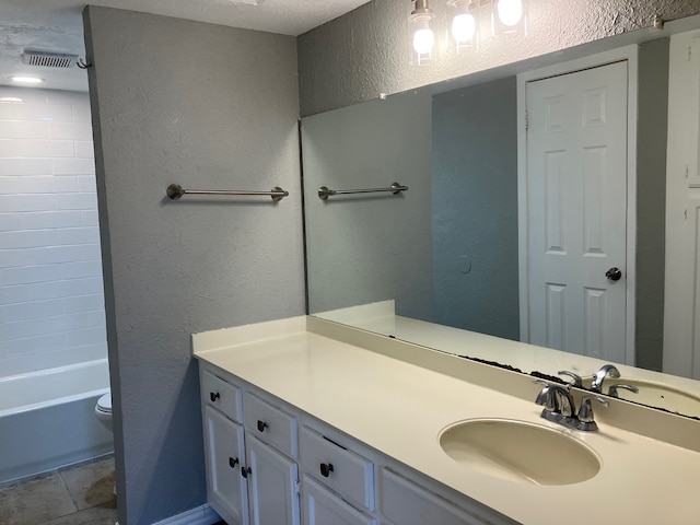 full bathroom with tile patterned floors, toilet, shower / bath combination, vanity, and a textured ceiling