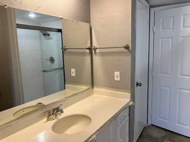 bathroom featuring vanity, tile patterned floors, and a shower with shower door