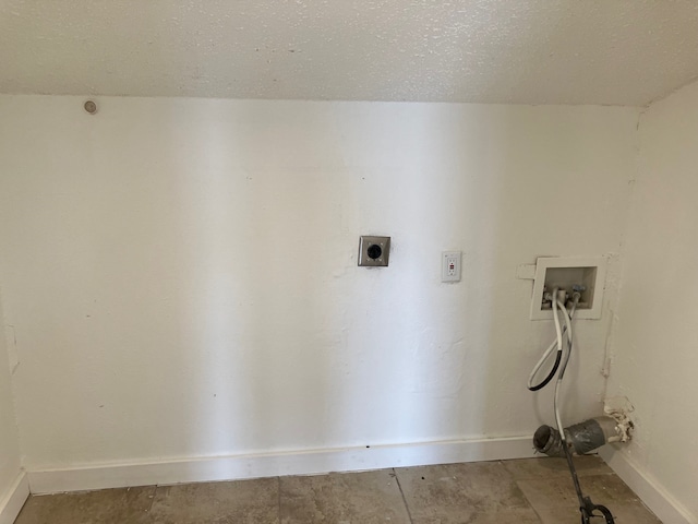 laundry room featuring hookup for a washing machine, a textured ceiling, and electric dryer hookup