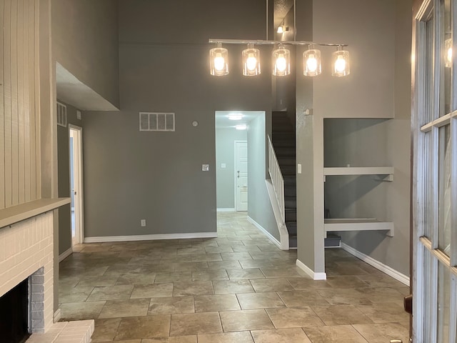 unfurnished dining area featuring a brick fireplace