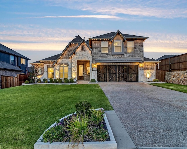 view of front of house with a garage and a lawn