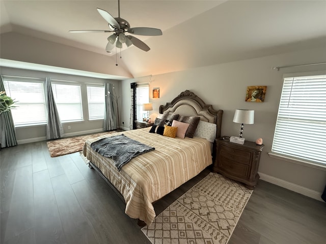 bedroom featuring dark hardwood / wood-style floors, multiple windows, and lofted ceiling