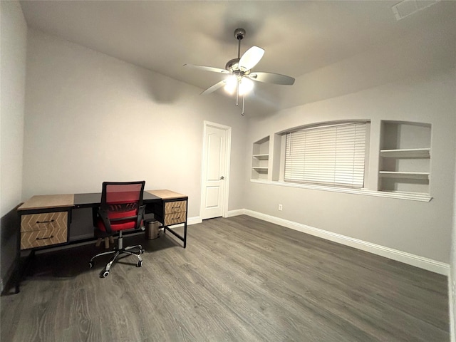 office area with ceiling fan, dark hardwood / wood-style flooring, and built in shelves