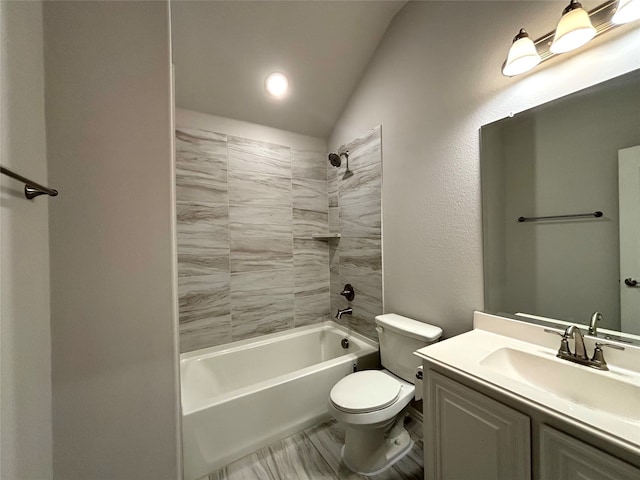 full bathroom with vanity, toilet, lofted ceiling, and tiled shower / bath