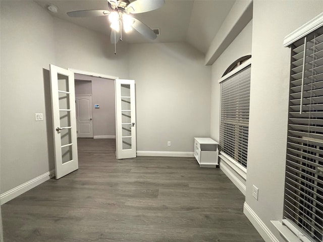 unfurnished bedroom featuring french doors, lofted ceiling, ceiling fan, and dark wood-type flooring