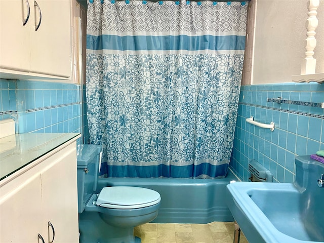 bathroom featuring tile patterned floors, shower / tub combo, tile walls, and toilet