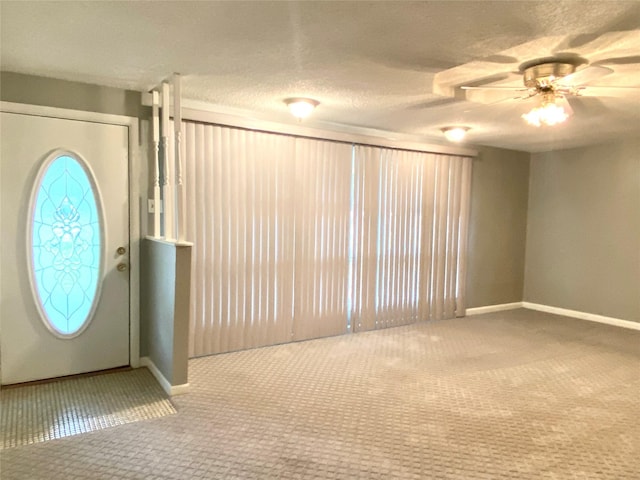 carpeted entryway featuring ceiling fan and a textured ceiling