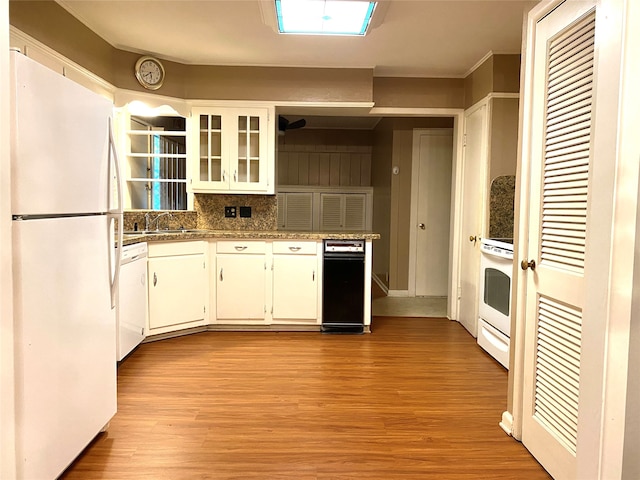 kitchen with white cabinets, white appliances, and light hardwood / wood-style flooring