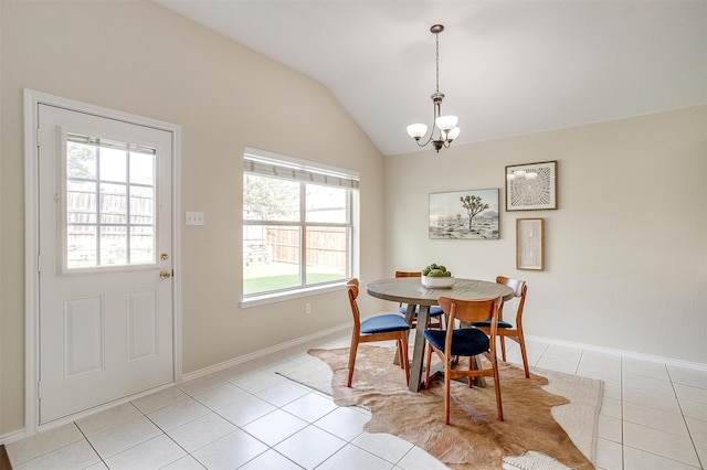 dining area with lofted ceiling, light tile patterned floors, and a notable chandelier