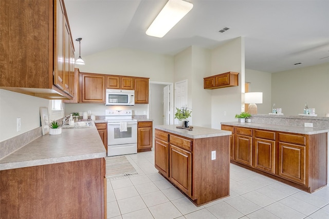 kitchen featuring white appliances, light tile patterned floors, pendant lighting, lofted ceiling, and a center island