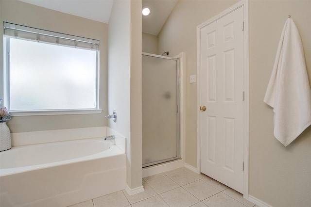 bathroom with independent shower and bath and tile patterned flooring