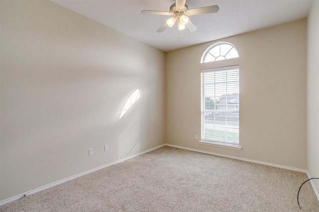 carpeted spare room with ceiling fan