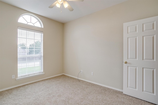 carpeted empty room featuring ceiling fan