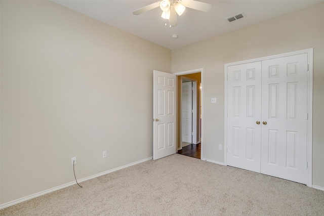 unfurnished bedroom with carpet floors, ceiling fan, and a closet