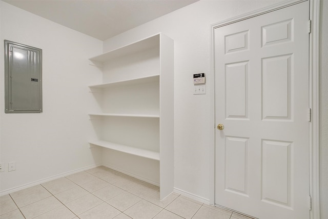 interior space with electric panel and light tile patterned flooring