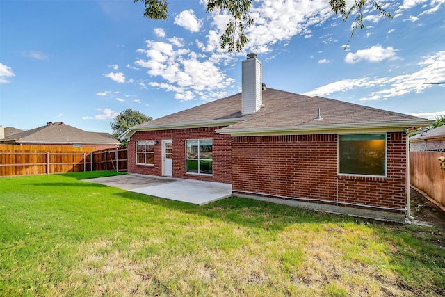 rear view of house featuring a patio area and a lawn