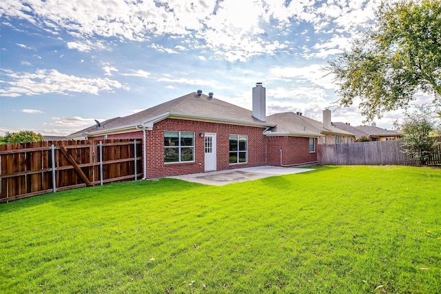 rear view of property featuring a patio area and a lawn