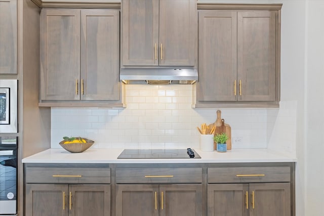 kitchen with backsplash and appliances with stainless steel finishes