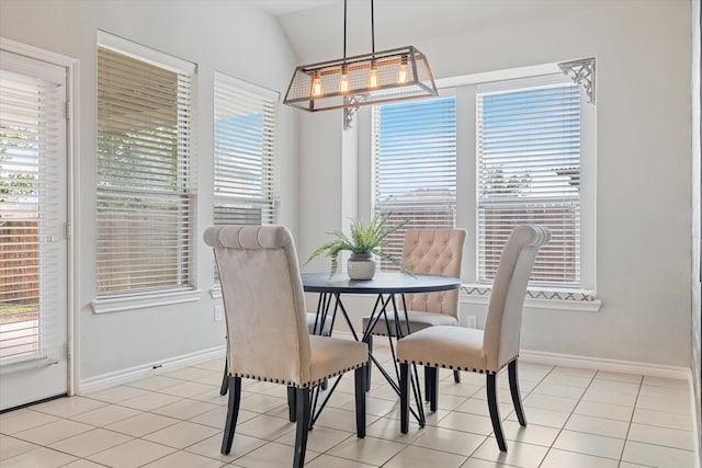 tiled dining room with vaulted ceiling