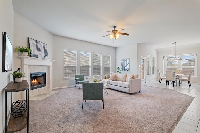 tiled living room with ceiling fan and plenty of natural light