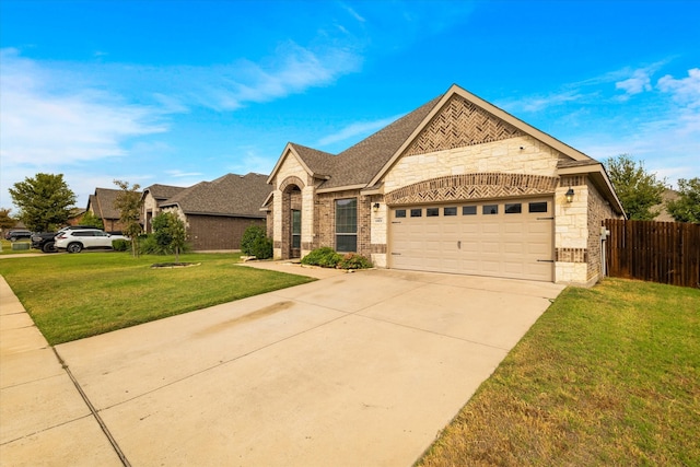 view of front of property featuring a front lawn and a garage