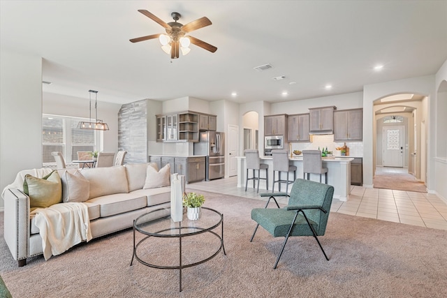 living room with light tile patterned flooring and ceiling fan