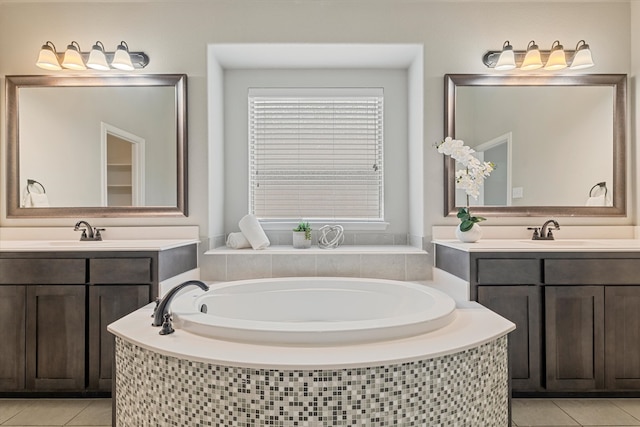 bathroom featuring vanity, tile patterned floors, and tiled tub