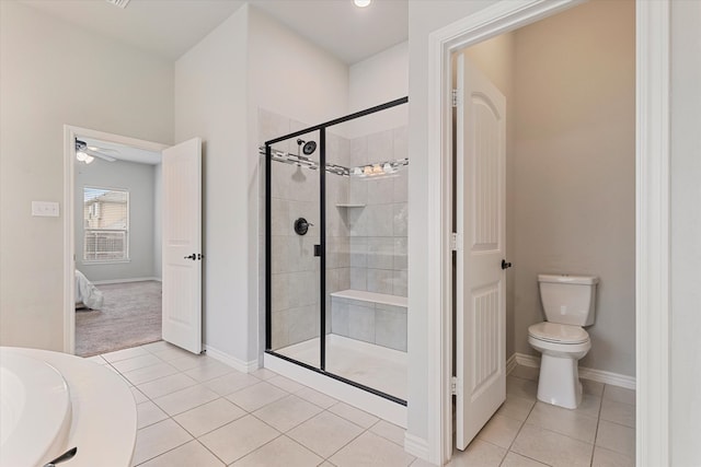 bathroom with toilet, walk in shower, ceiling fan, and tile patterned flooring