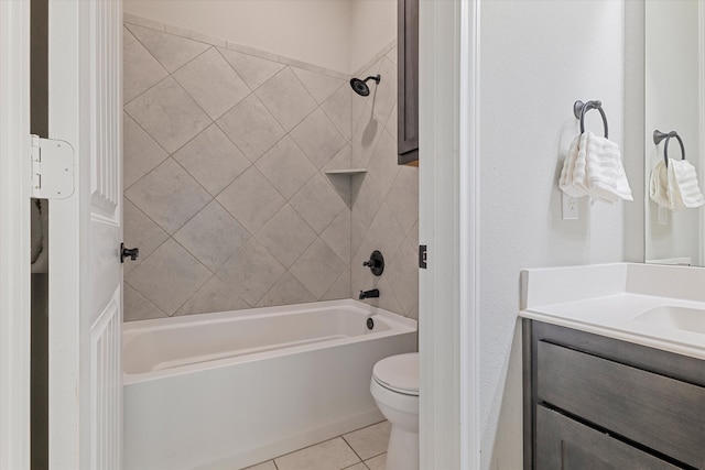 full bathroom featuring tiled shower / bath, vanity, toilet, and tile patterned floors