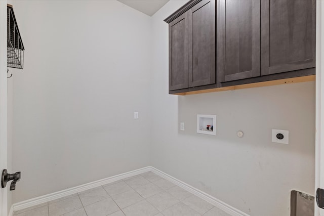 laundry room featuring hookup for an electric dryer, gas dryer hookup, cabinets, washer hookup, and light tile patterned floors