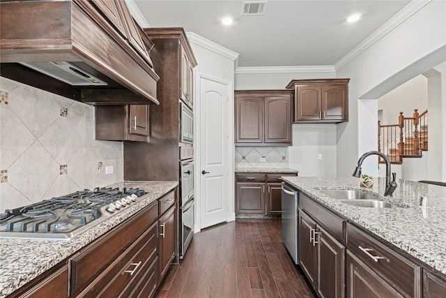 kitchen featuring dark hardwood / wood-style floors, stainless steel appliances, sink, dark brown cabinetry, and premium range hood