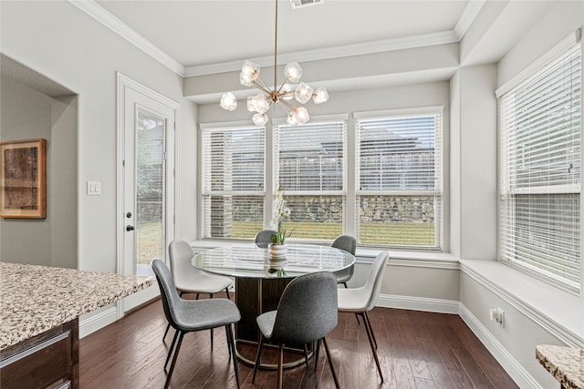 dining room with dark wood-type flooring, crown molding, and a chandelier