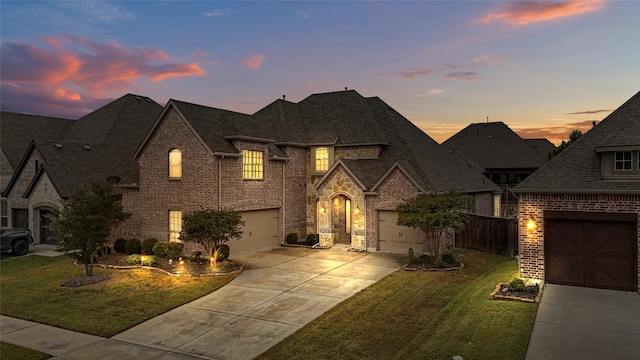 view of front of home with a yard and a garage