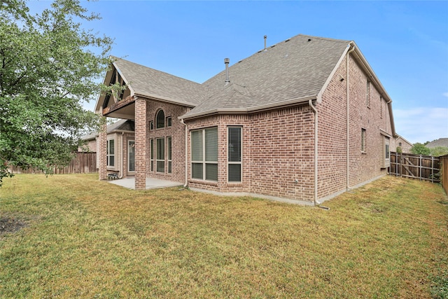 rear view of property with a patio and a yard