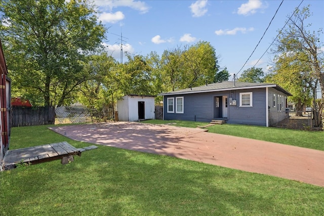 back of house featuring a patio, a storage unit, and a lawn