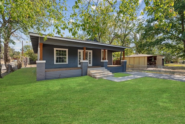 view of front facade with a front lawn and covered porch