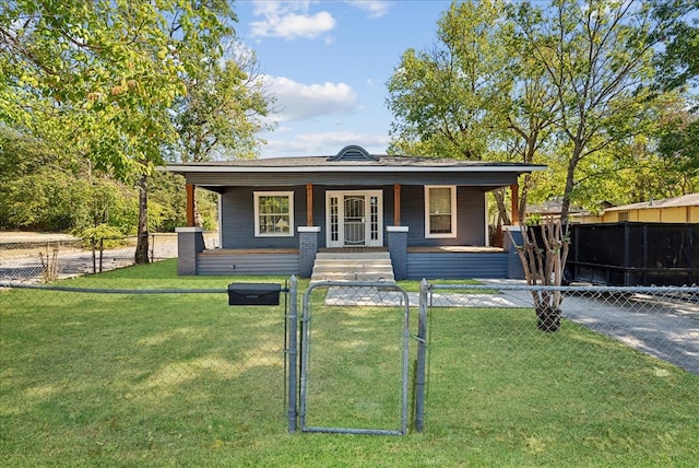 bungalow with covered porch and a front lawn