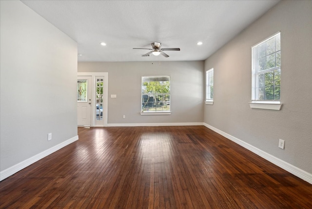 spare room with ceiling fan and dark hardwood / wood-style flooring