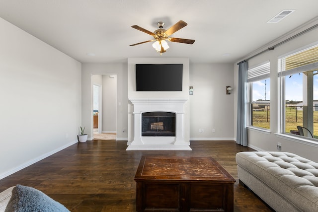 living room with ceiling fan and dark hardwood / wood-style floors