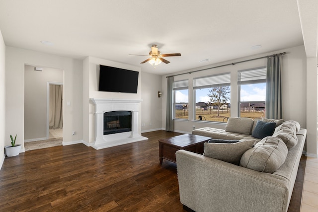 living room with dark hardwood / wood-style floors and ceiling fan