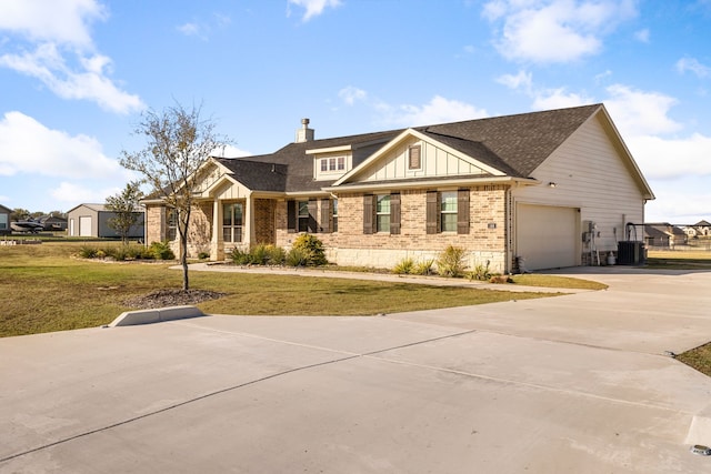 craftsman-style house with central AC unit, a garage, and a front lawn