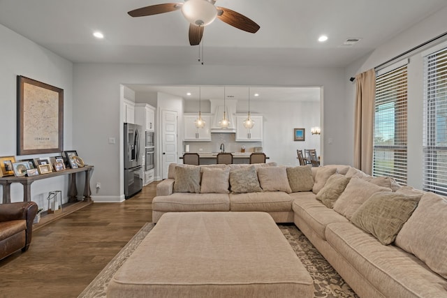 living room with sink, ceiling fan, and dark hardwood / wood-style floors