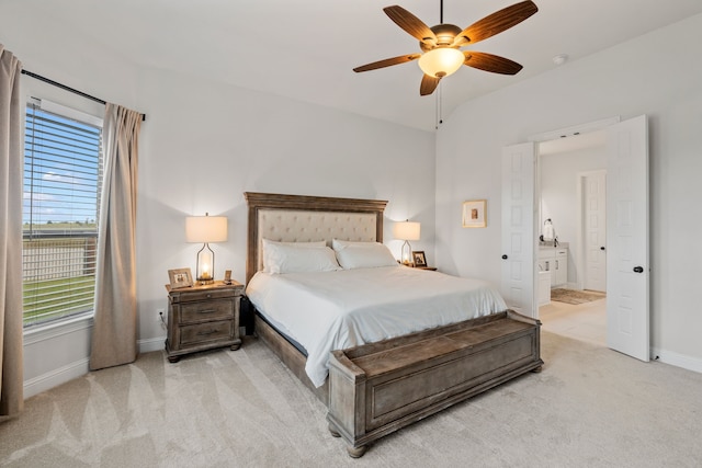 bedroom with lofted ceiling, light colored carpet, ceiling fan, and multiple windows