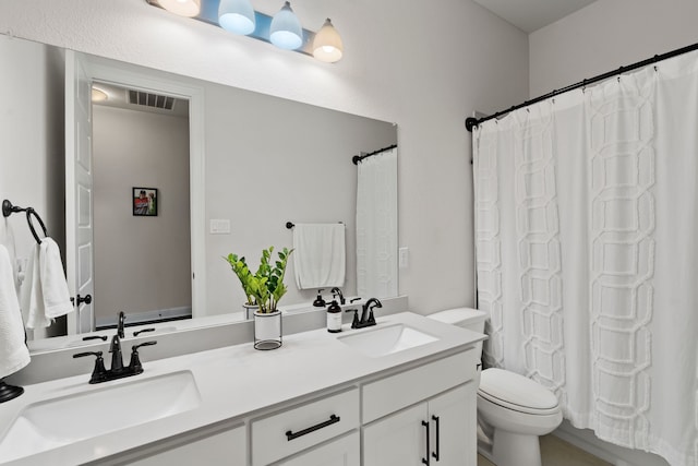 full bathroom featuring toilet, shower / tub combo, and vanity