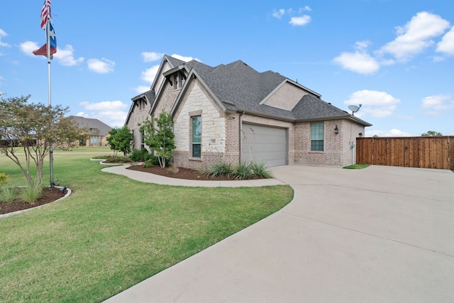 view of front of property featuring a front yard and a garage