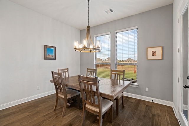 dining space with a chandelier and dark hardwood / wood-style floors